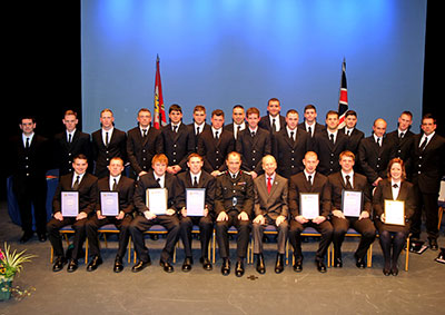 All the recuits pictured on stage in formal undress uniform in two rows