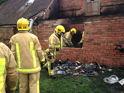 Firefighters examine fire damage