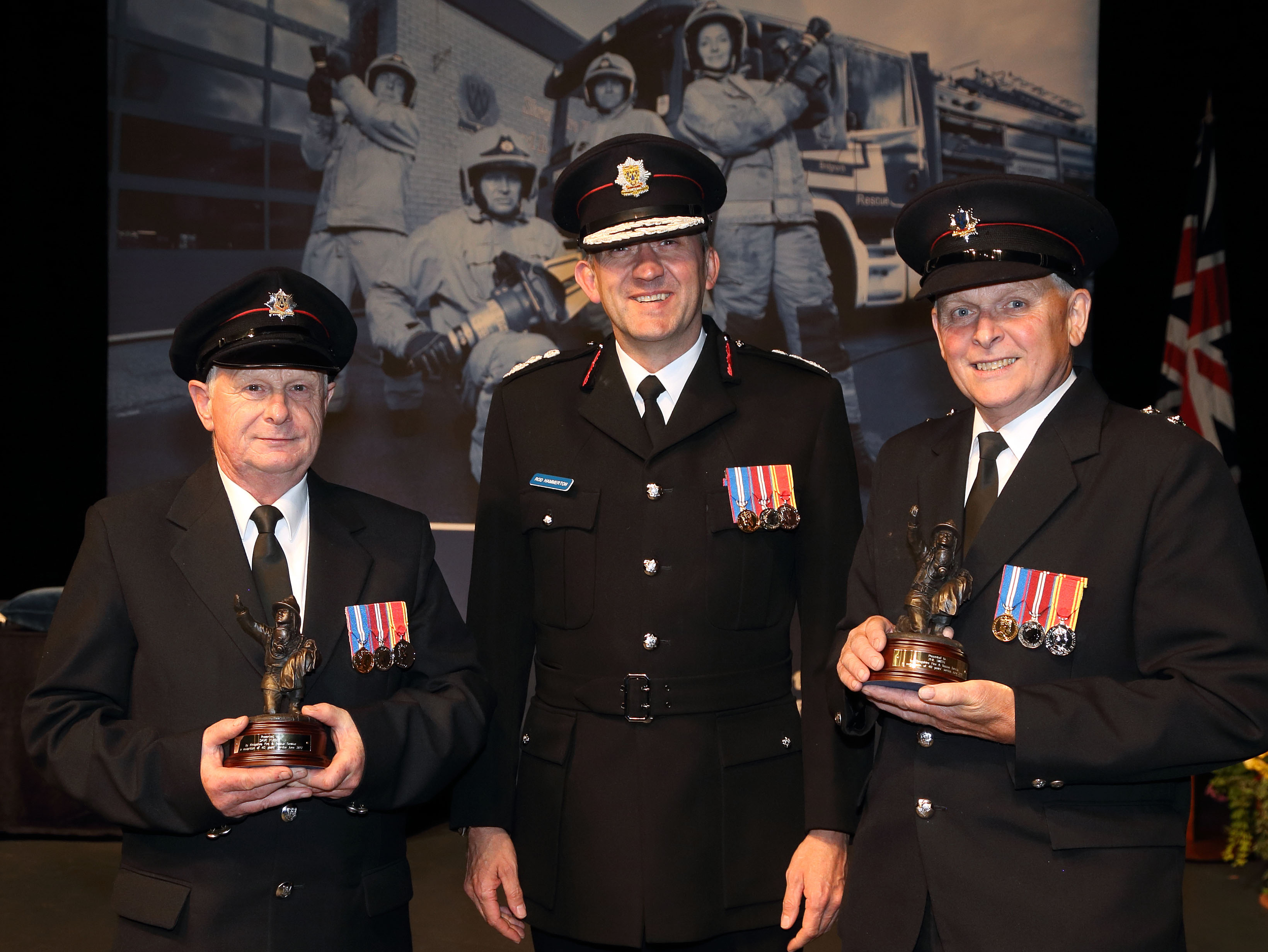 Wem firefighters Phil Smith and Dave Furber celebrate more than 40 years service each, pictured with Chief Fire Officer Rod Hammerton.