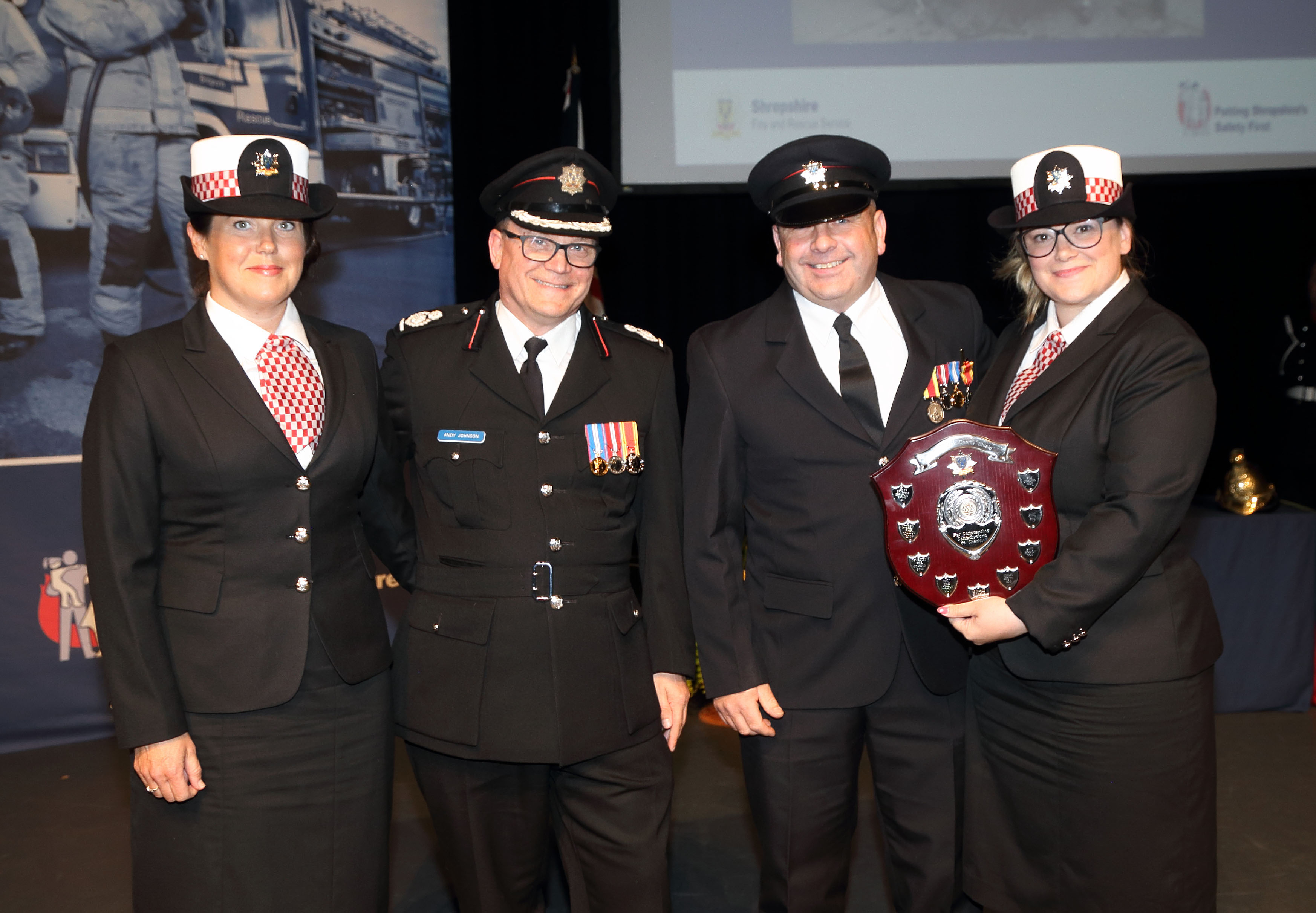 Assistant Chief Fire Officer Andy Johnson presents the Telent Charity Shield to employees who organised a three day 240 mile cycle challenge which raised £4,000 for charity. Pictured left to right, Vickie Phillips, Andy Johnson, Graham Oliver, and Katy Lowe.