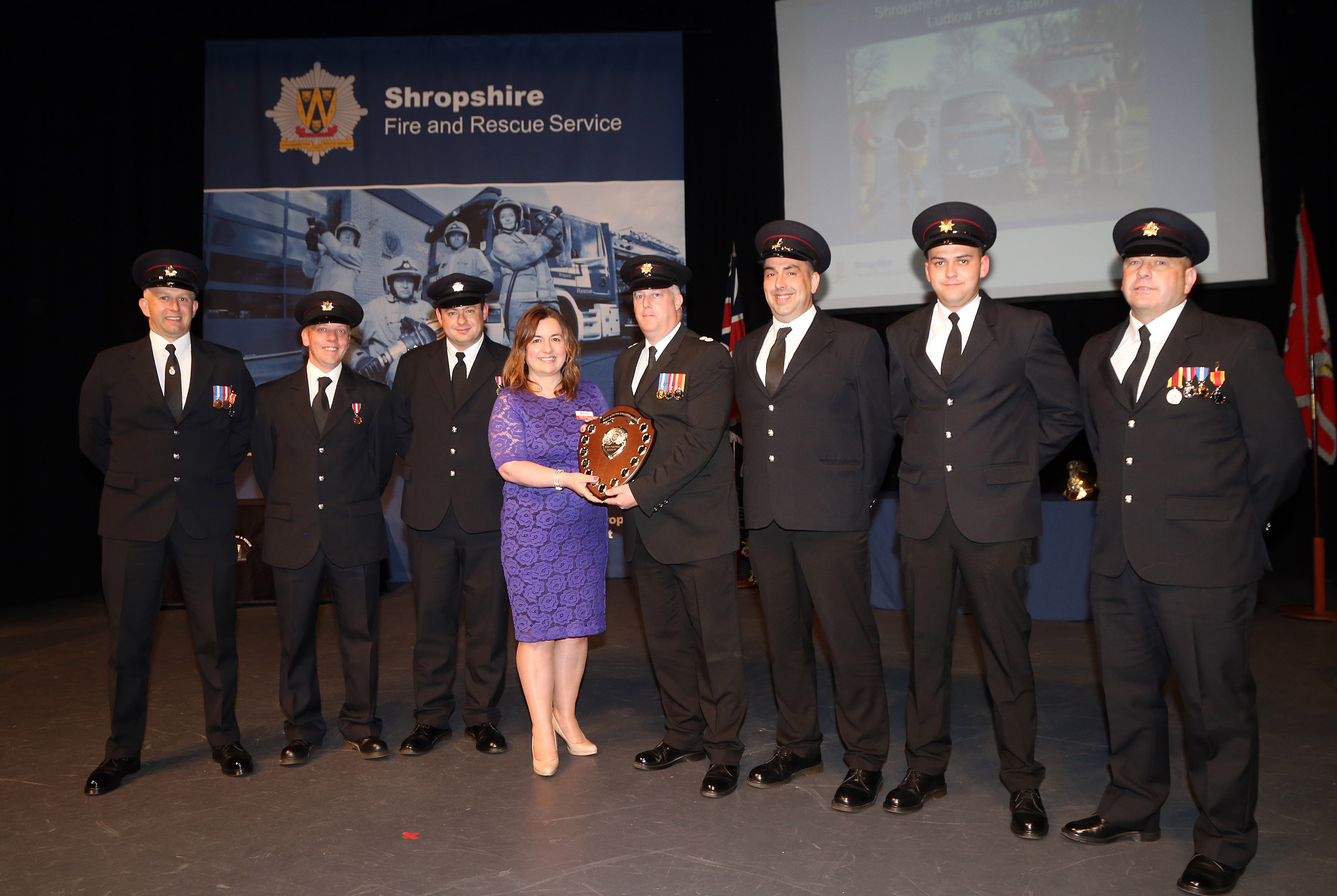 Ludlow Fire Station was awarded the Dave Bishton Challenge Shield for raising more than £4,000 for the Fire Fighters Charity over the past year. Pictured are, left to right, Steve Perks, Mark Nicholas, Ashley Brown, Charity fundraising officer Debbie Rushbrooke, Watch Manager Glyn Davies, Shaun Harrison, Olie Powis and Graham Oliver.
