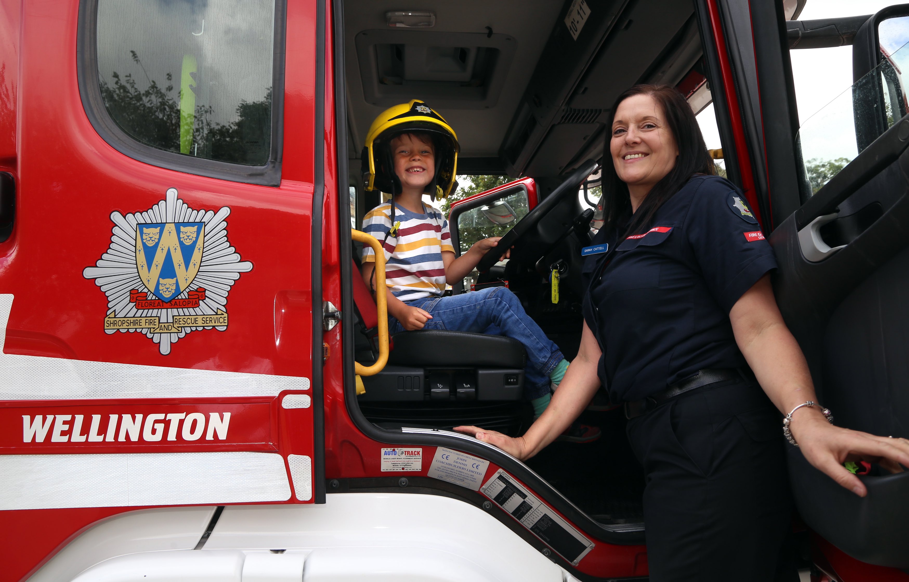 It’s fun in a fire engine. Ethan Armstrong, from Telford, with firefighter Sarah Cattell.