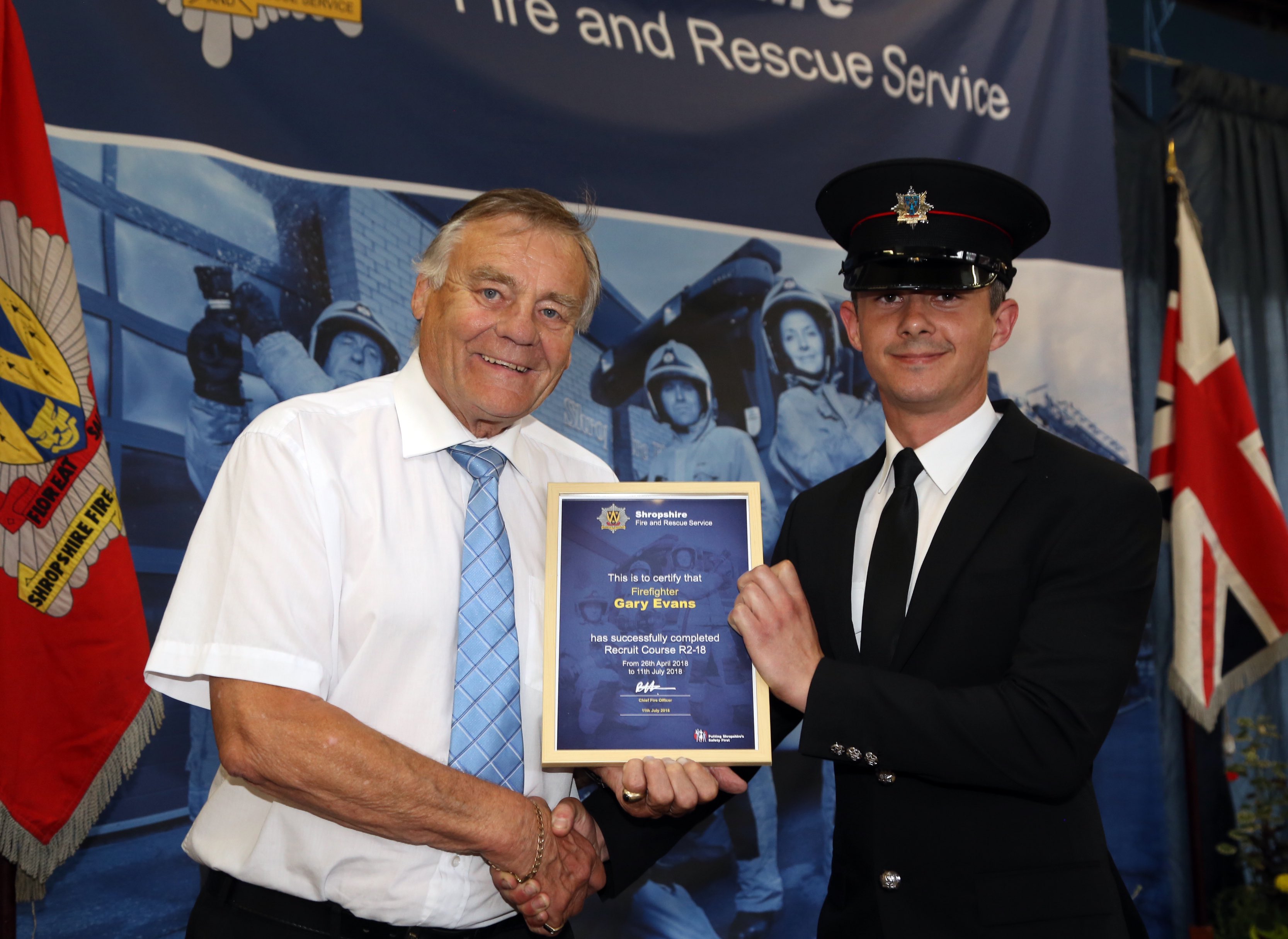 Shropshire and Wrekin Fire Authority chairman, Councillor Eric Carter, presents recruitment certificates to firefighters. Gary Evans also won the instructors' award