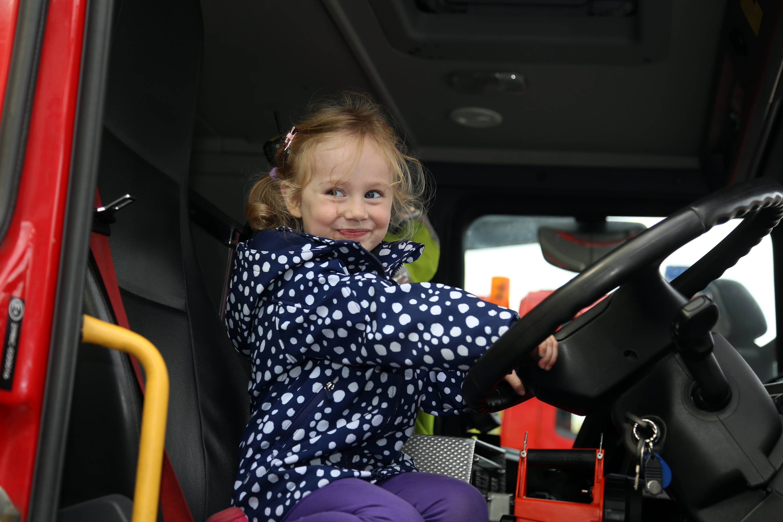 Enid Round, age 3 from Shrewsbury behind the wheel of a fire engine.