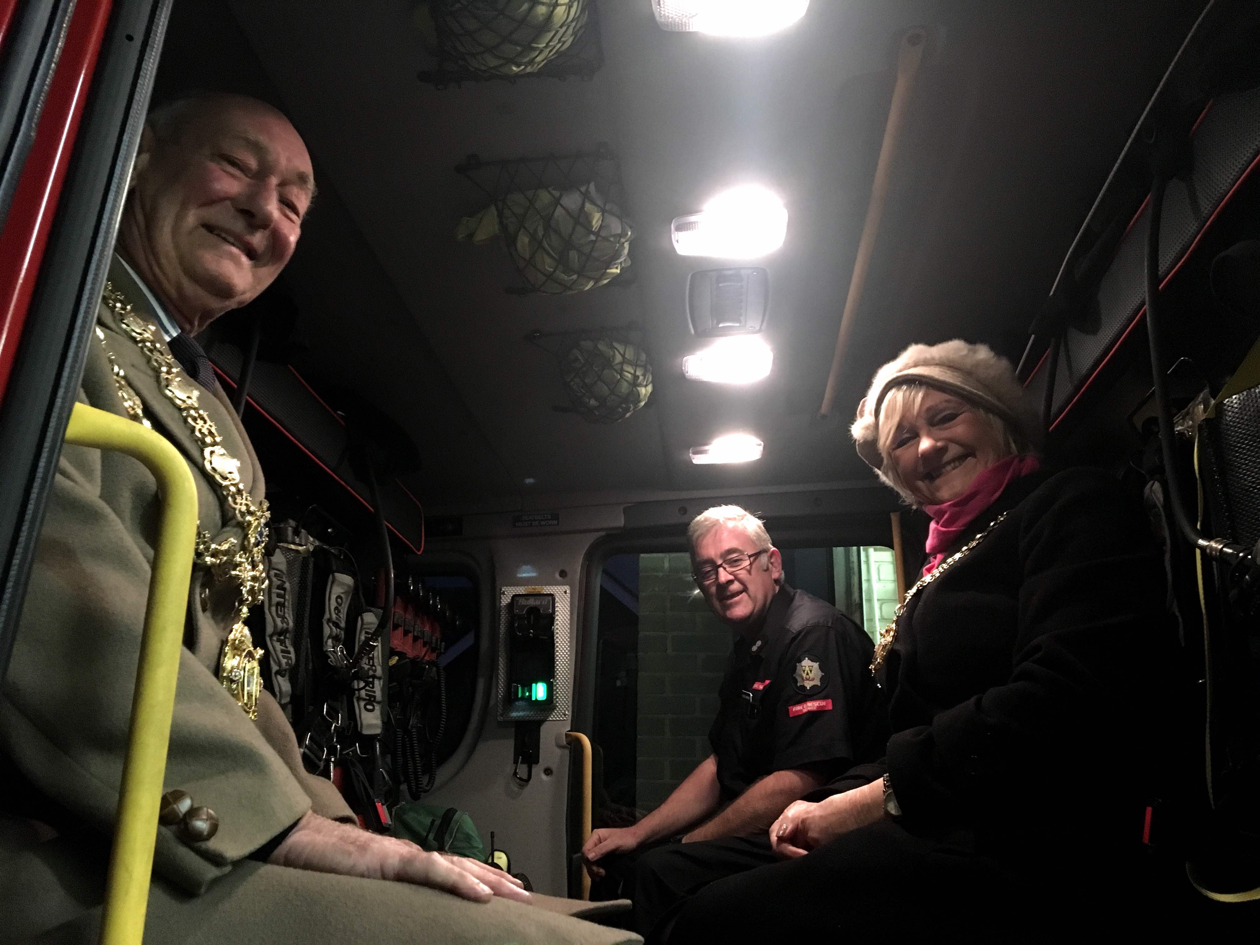 Much Wenlock Mayor, Councillor Graham Edgcumbe Venning and wife Christine take a seat aboard the new fire appliance with Watch Manager Alastair Humphries.  