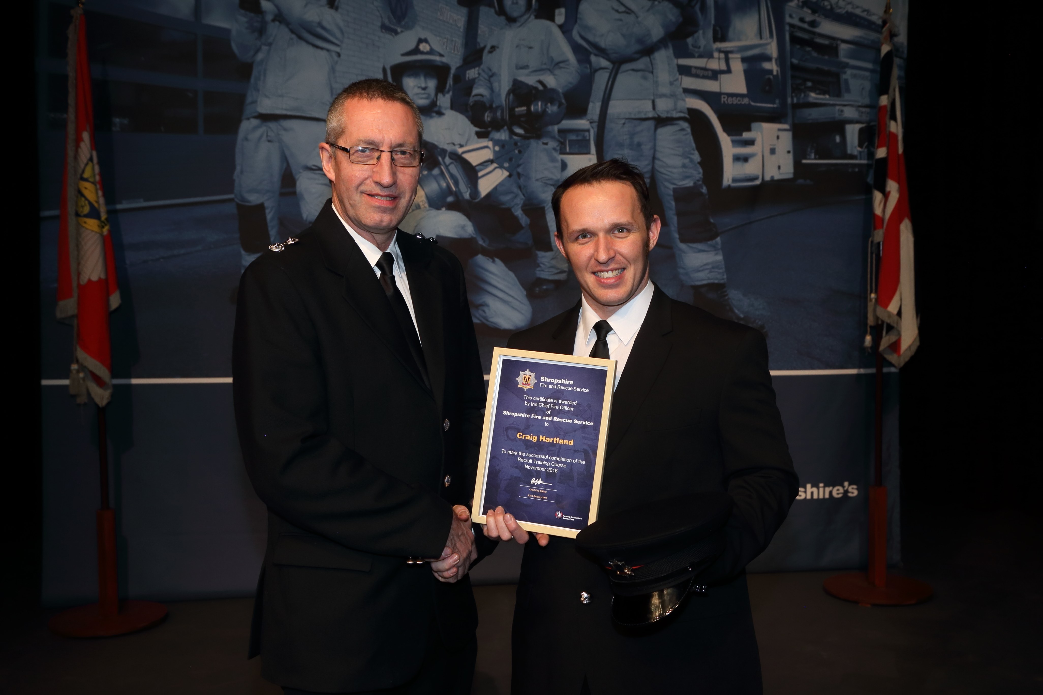 Aldi supermarket stock assistant Craig Hartland receives his certificate from Newport Watch Manager Charlie Cartwright.(left)