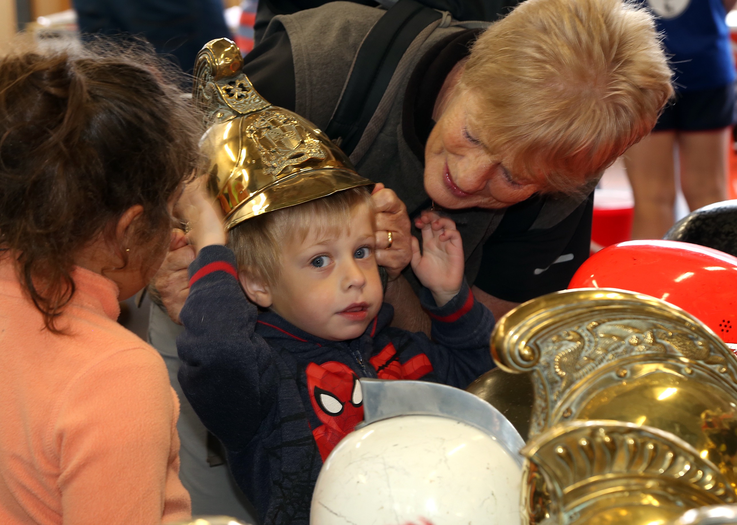 Ben Jones (aged 3) tries on a firefighter’s helmet for size pictured with his grandmother Sue Challinor, from Shrewsbury.