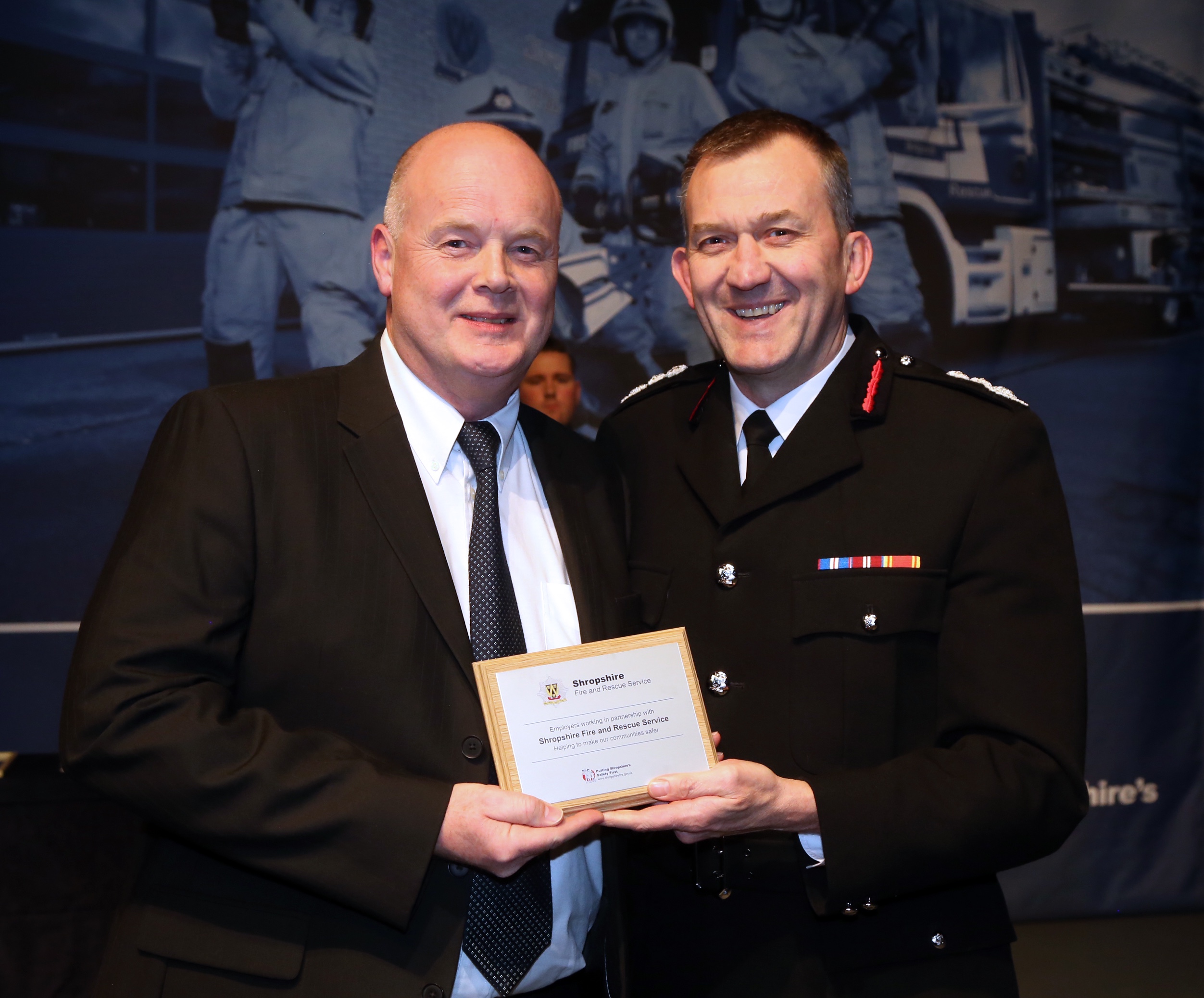 Europa Fastenings MD Stephen Cowan with the employers' award from Chief Fire Officer Rod Hammerton