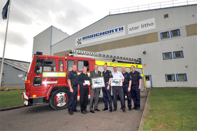 Fire appliance with firefighters presenting plaque to Simon MacVicker, Bridgnorth Aluminium MD