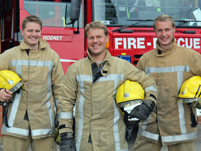 Brothers pictured in fire kit in front of fire appliance