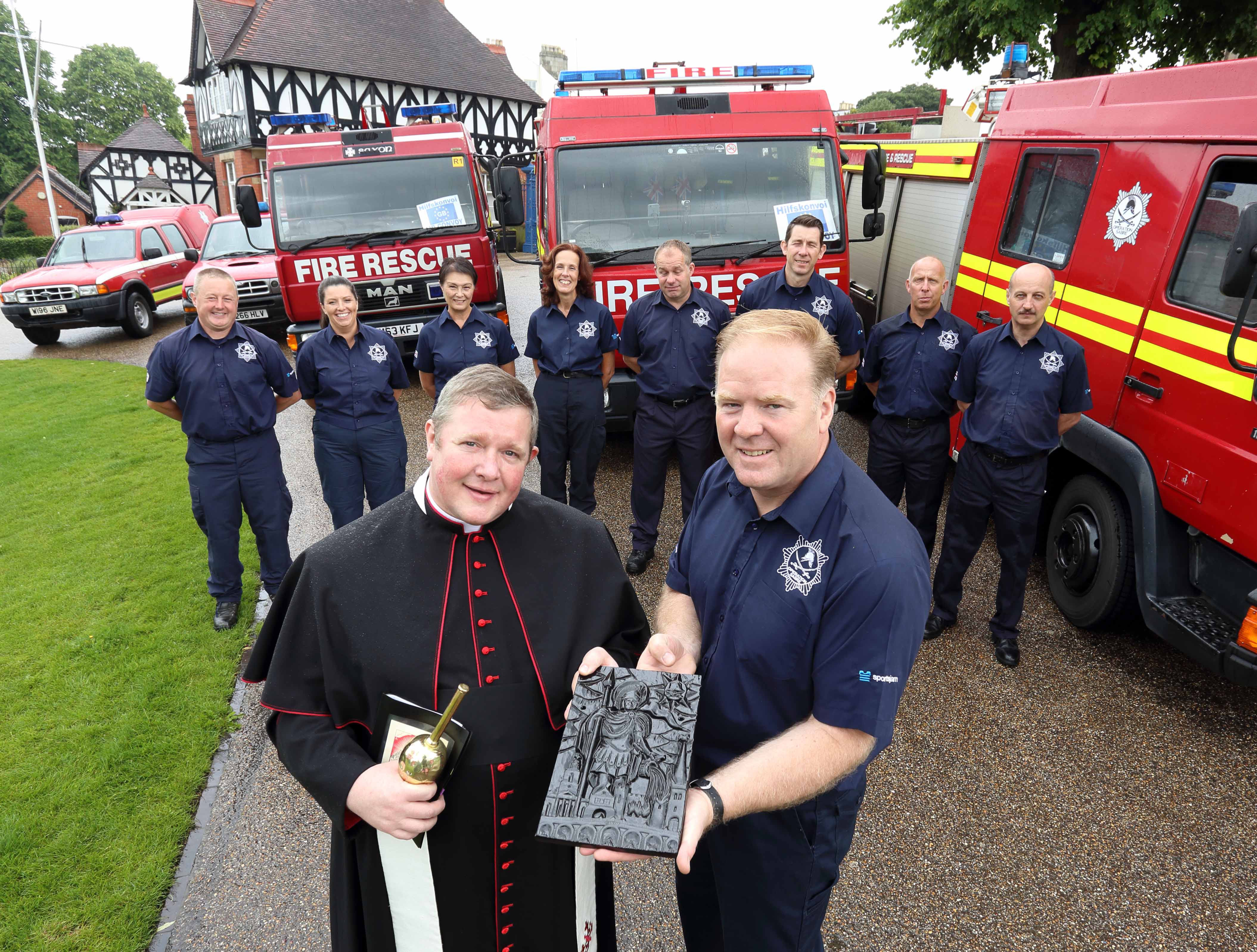 The Very Reverend Canon Jonathan Mitchell with Dr Steve Worrall at the blessing of the fire appliances before Shrewsbury charity Operation Sabre sets off for Romania.