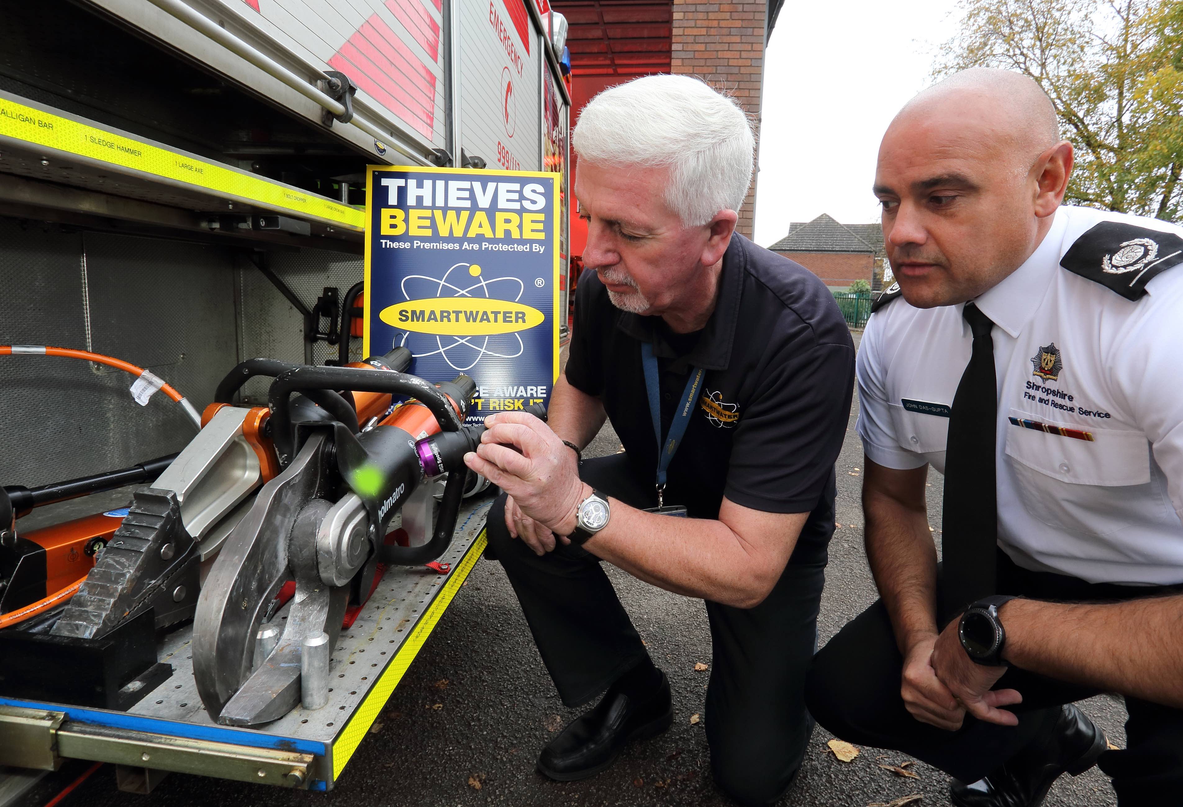 SmartWater’s Steve Mills, a former crime squad officer, shines an ultra violet light to identify stolen equipment and entrap thieves with Area Manager John Das Gupta and Andy Bevon (left), of Shropshire Fire and Rescue Service, at the scene of a “first ever” crime at Albrighton Fire Station.