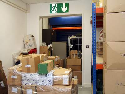 photo of a really cluttered corridor leading to a fire exit