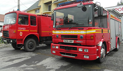 Two fire appliances parked next to each other, one old one new