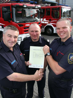 Dave Dickens and Mike Price hand certificate to Kent Hallihan