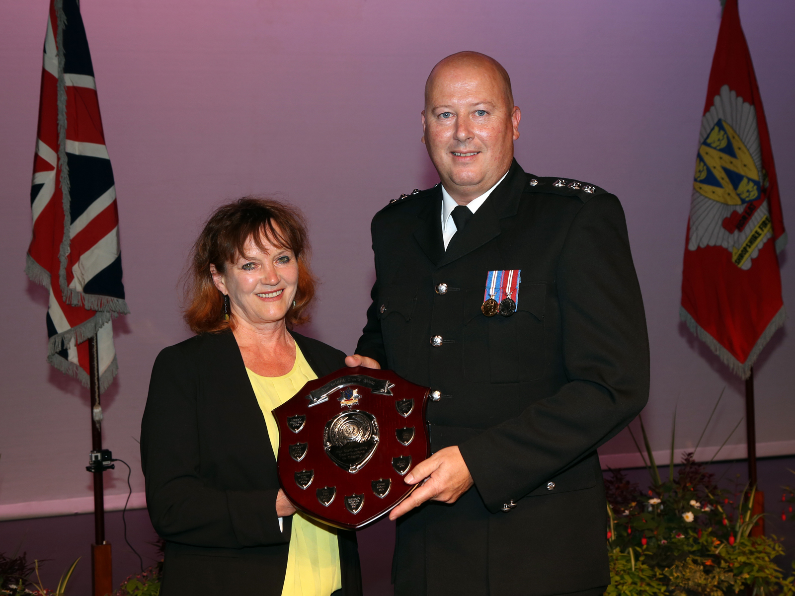 Councillor Jean Jones presents the Telent Charity Shield to Group Manager Rob Corfield for his “outstanding” contribution to charity.