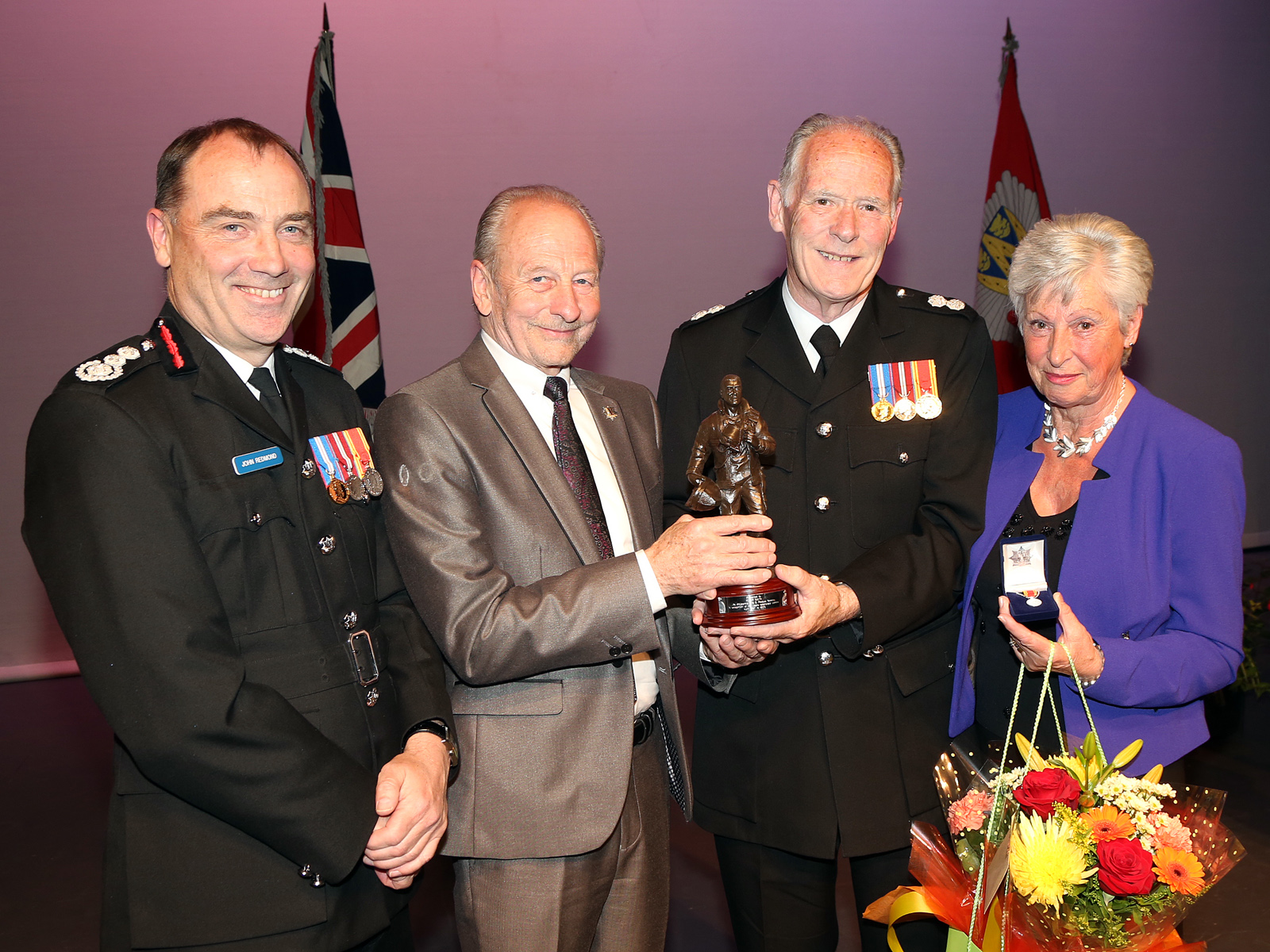 The UKs longest serving firefighter Roger Smith with wife Margaret receive a special award on his retirement after 48 years service - the UKs longest serving firefighter - from Chief Fire Officer John Redmond and fire authority chairman Stuart West.