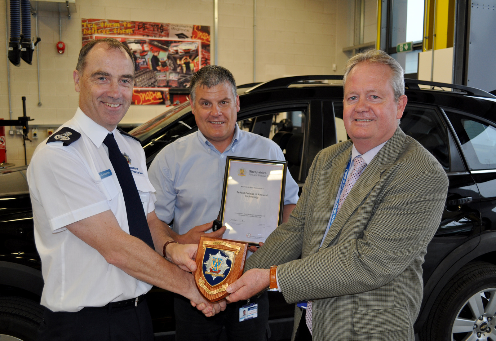 Chief Fire Officer John Redmond thanks TCATs John Hampson (centre) and Jim Hillman.