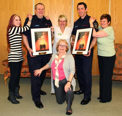 Staff and firefighters pose with awards