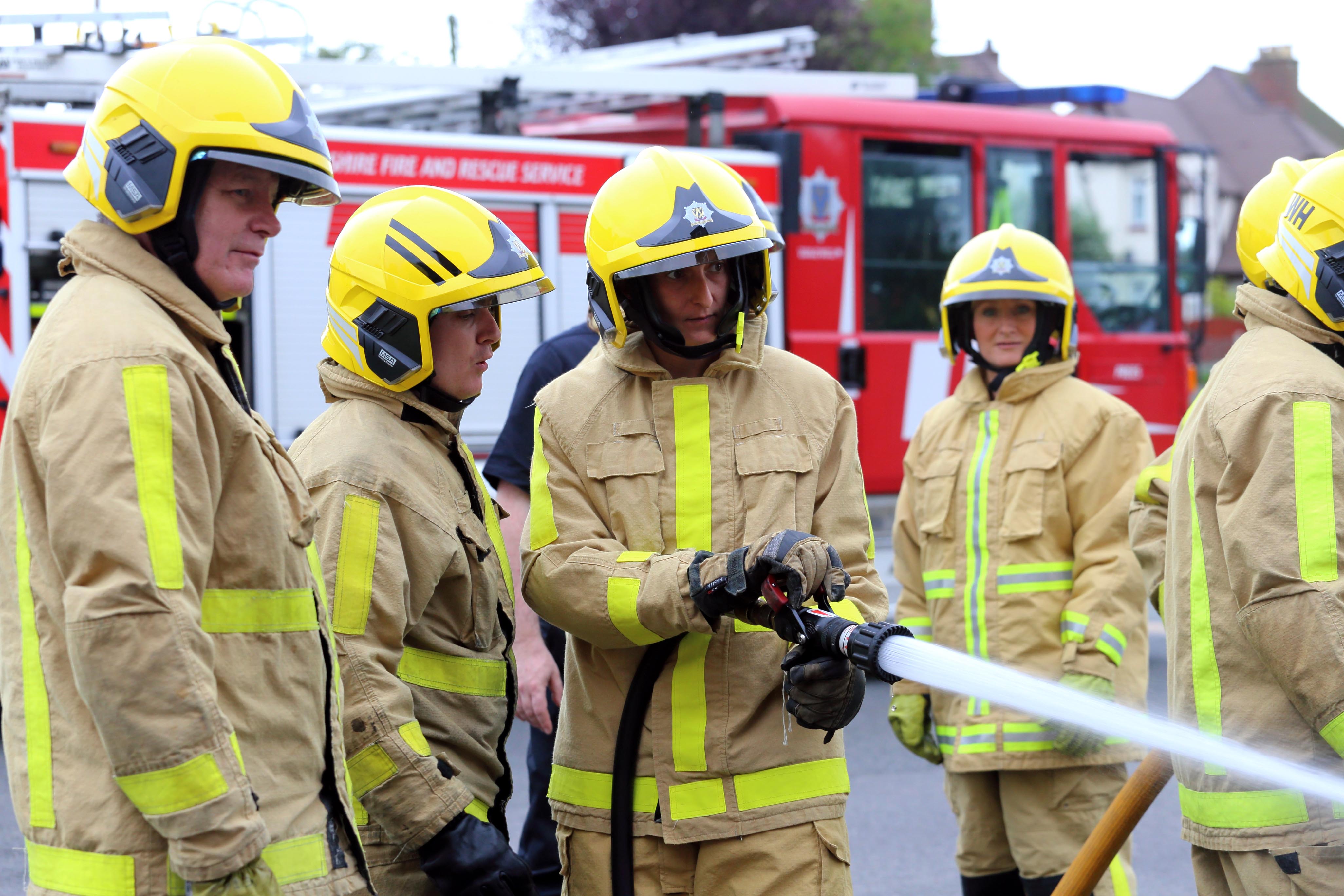 Julie Collins tries out the firefighter hose at the taster event. 