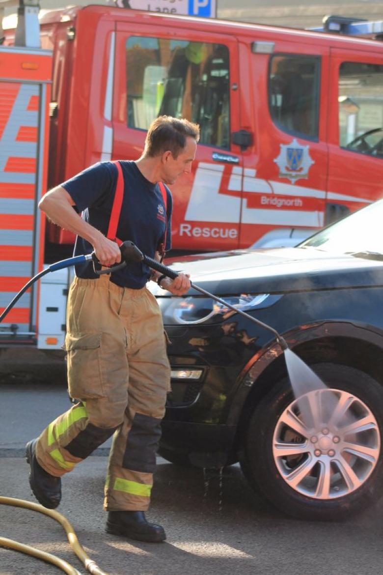 Bridgnorth firefighter John Allen in action during the charity car wash