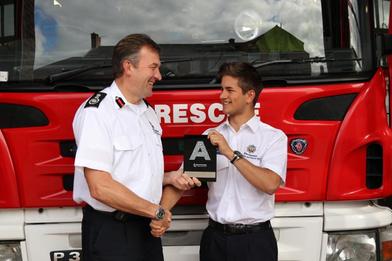 Chief Fire Officer Rod Hammerton (left) presents Dan Adams with his award.