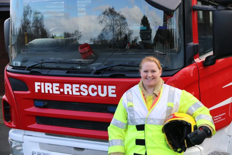 Baschurch firefighter Elaine poses in front of a fire engine