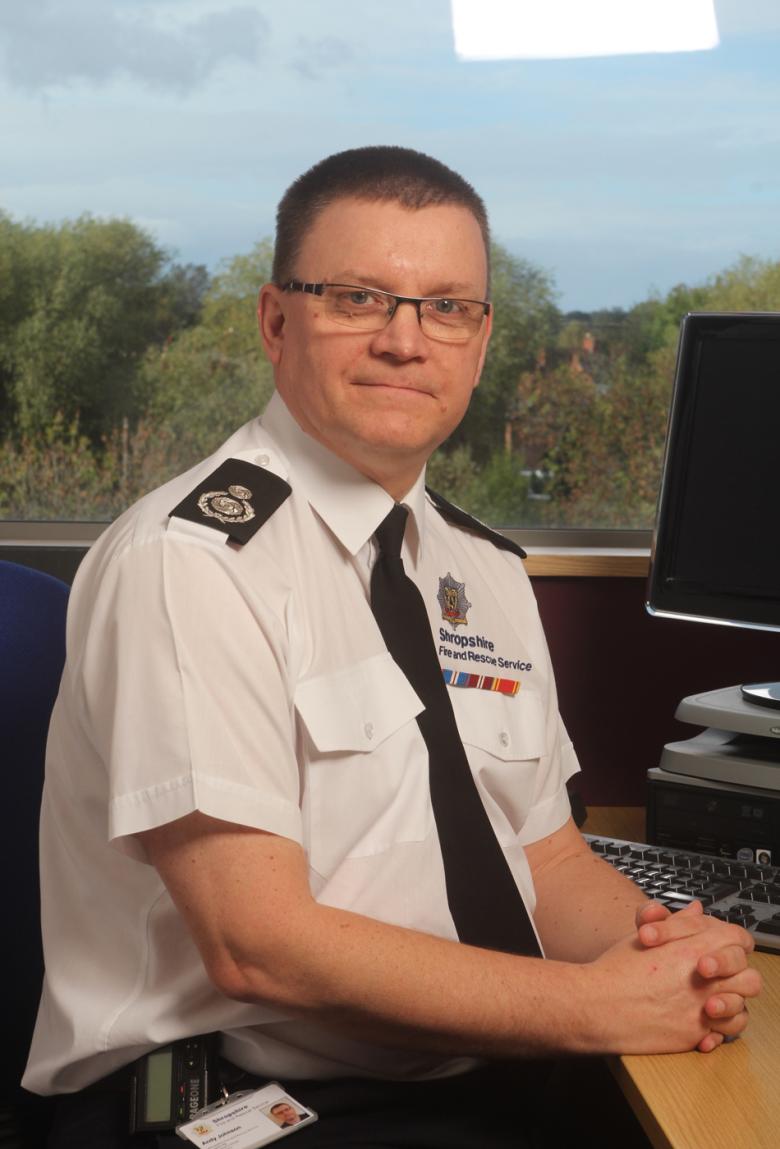 picture of assistant chief fire officer Andy Johnson at his desk