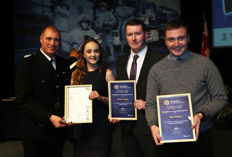 Assistant Chief Fire Officer Dave Myers presents achievers’ awards to apprentices Emily Hodson, Deryn Jones and Matt Titley (right)
