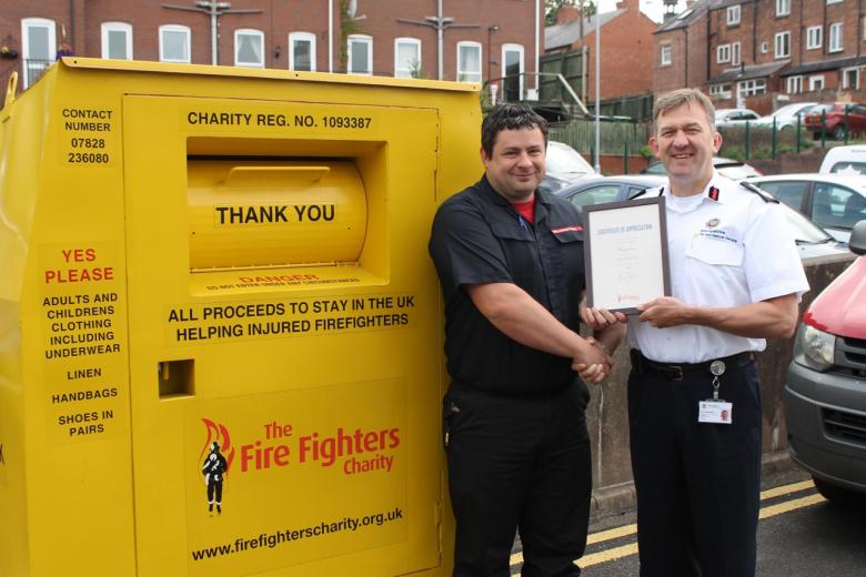 Charity Service co-ordinator Ashley Brown receives the Fire Fighters’ Charity certificate of appreciation from Chief Fire Officer Rod Hammerton at one of their fund raising recycling collection points at Shrewsbury fire HQ.