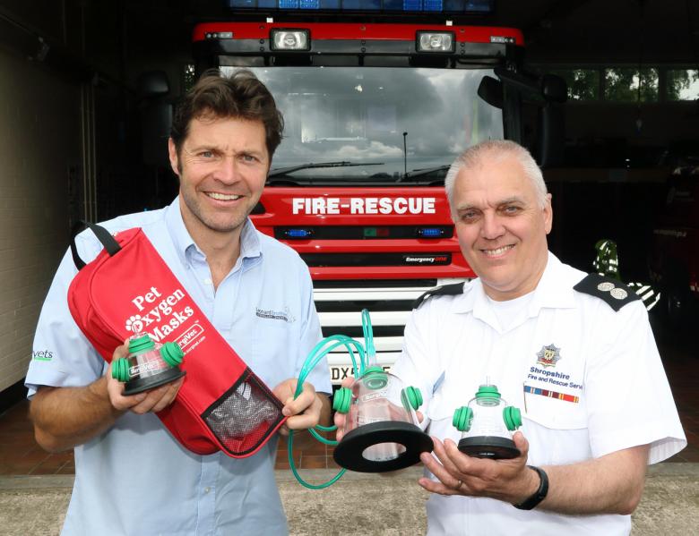 Whitchurch vet Steve Leonard hands over a pet oxygen mask to Martin Huckle at Whitchurch Fire Station as part of the life saving pets campaign.