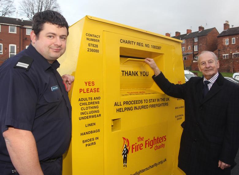 Charity Service Co-ordinator Ashley Brown (left) and Shropshire and Wrekin Fire Authority chairman Stuart West at one of the textile recycling banks at 17 Shropshire fire stations which have raised more than £6,000  for the Fire Fighters’ Charity.
