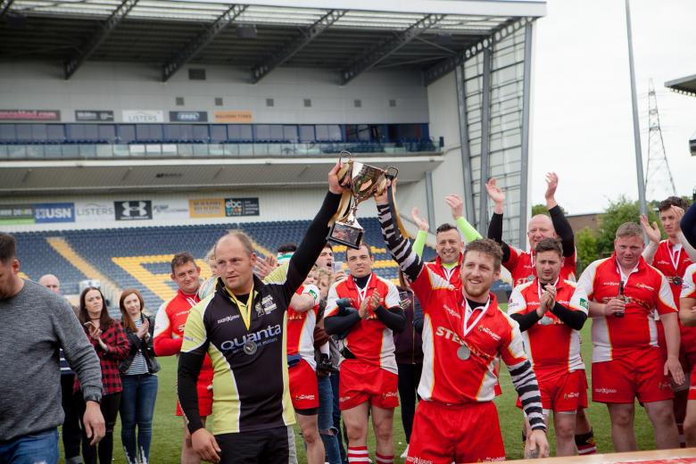 Bridgnorth firefighter Luke Veal (in green sleeves) celebrates the end of the 30 hour world beating rugby challenge for charity