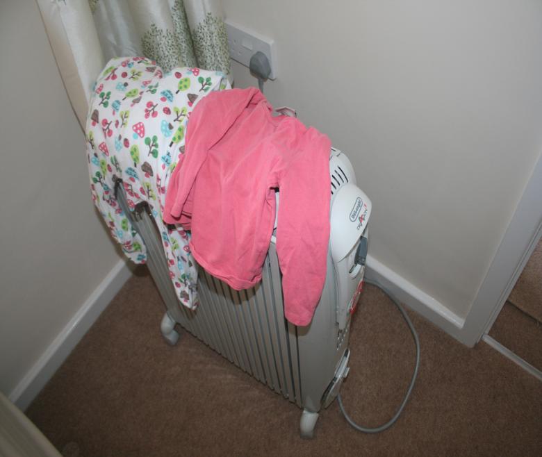 Drying clothes on a portable heater is a fire hazard