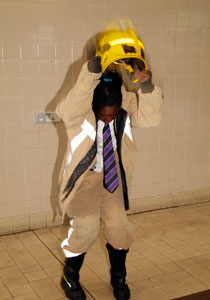 Young student dressing in fire kit puts on helmet