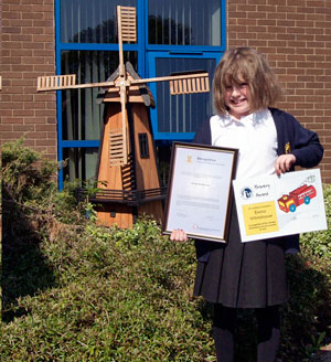 Emma smiling and holding her award