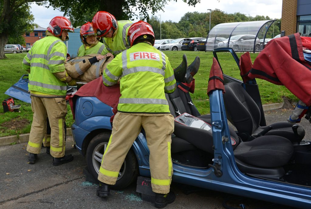 Lord Digby Jones with left to right Shropshire Chief Fire Officer John Redmond and TTC Group Road Safety Director Alan Prosser with firefighters after a car extrication demo as part of the business driver road safety campaign.