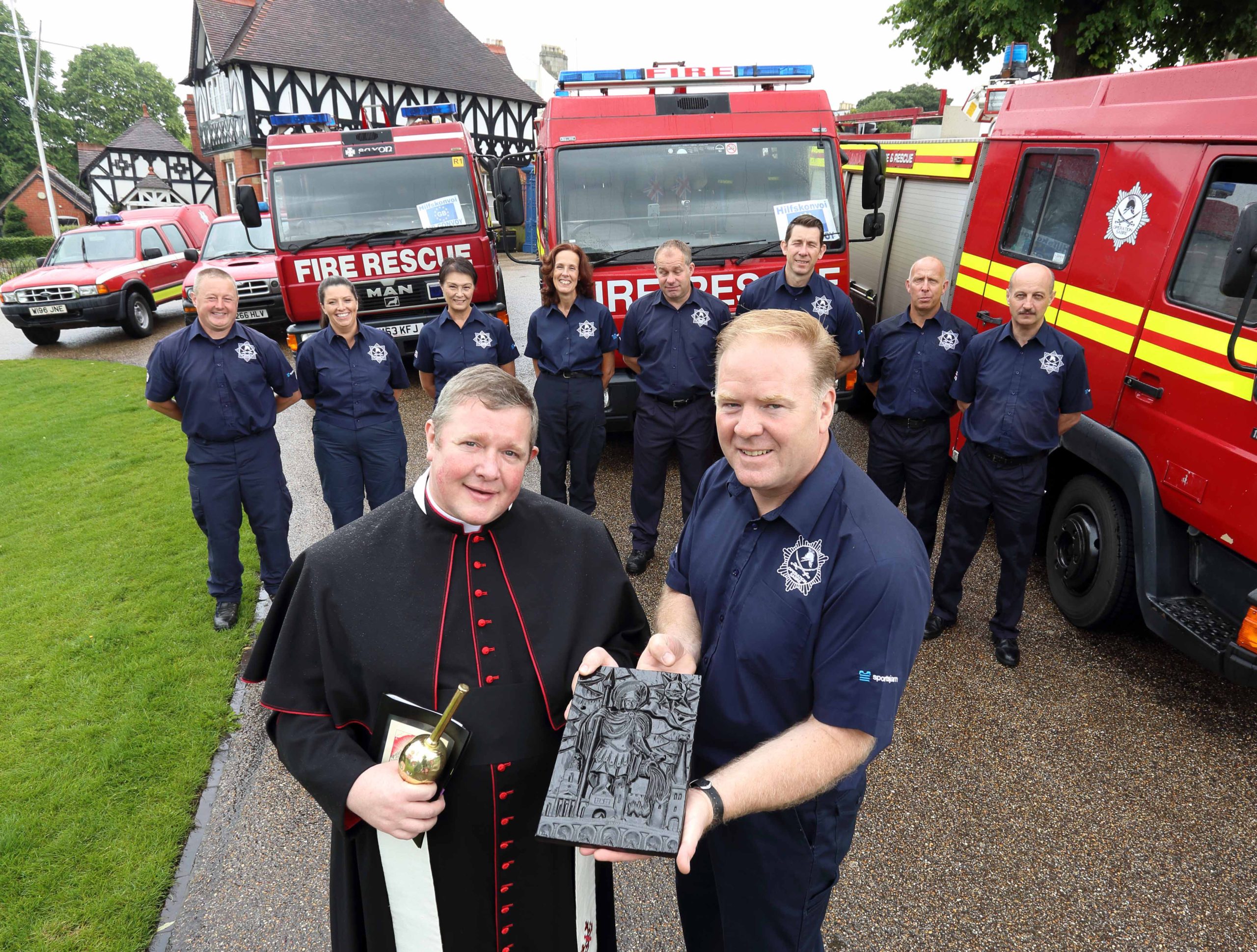The Very Reverend Canon Jonathan Mitchell with Dr Steve Worrall at the blessing of the fire appliances before Shrewsbury charity Operation Sabre sets off for Romania.