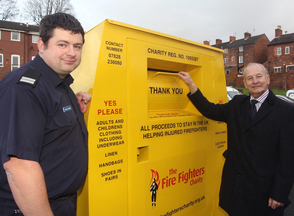 Charity Service Co-ordinator Ashley Brown (left) and Shropshire and Wrekin Fire Authority chairman Stuart West at one of the textile recycling banks at 17 Shropshire fire stations which have raised more than £6,000  for the Fire Fighters’ Charity.