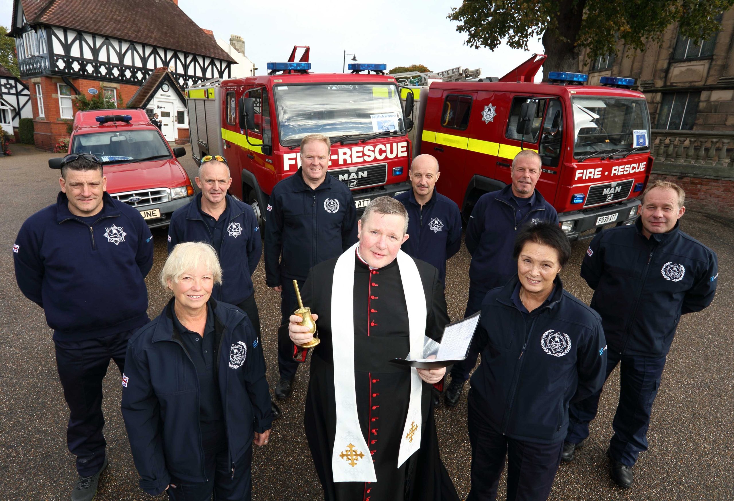Canon Jonathan Mitchell, the Dean of Shrewsbury Cathedral, blesses the fire engines in a traditional ceremony in Shrewsbury before the trip to Romania. He is pictured with Ann Lewis (left) and Jean Jones with (back row) firefighters Scott Hurfield and John Hammond with Steve Worrall, Shropshire and Wrekin Fire Authority member Councillor Mal Price, Mark Briscoe and Steve Purslow.