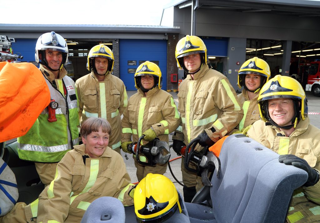 In the “hot seat” is Shropshire’s High Sheriff Christine Holmes (below left) after being cut free from a car by firefighters from Shrewsbury’s Green Watch who train regularly to rescue county road crash victims. L to r: Watch Manager Alex Howell with firefighters Geraint Lewis, Bev Morris, Steve Mason, Kate White and Mitch Thorne at Shrewsbury fire HQ.