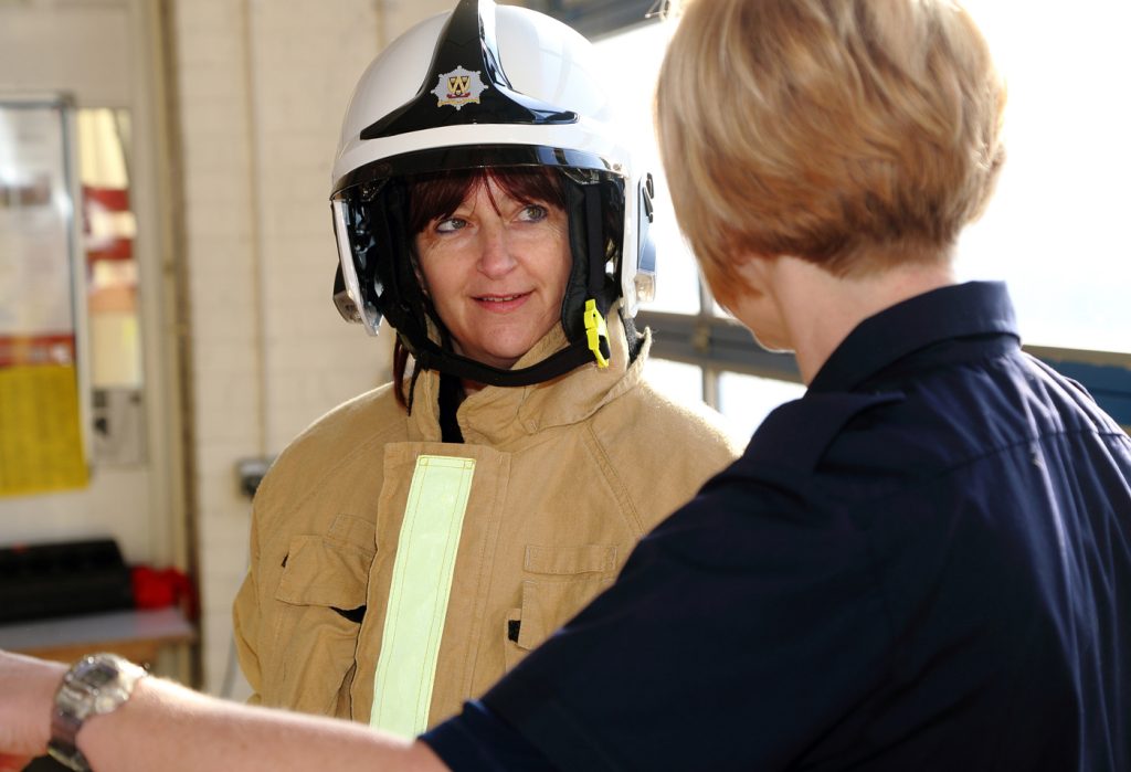 Oswestry’s Liz Killvert listens to firefighter Ruth Walkerdine.